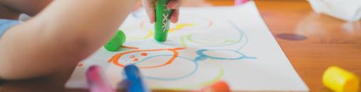 A child playing with markers.